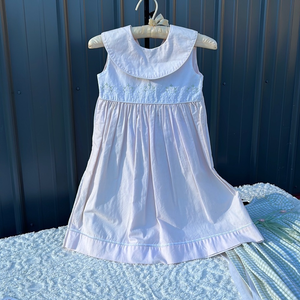 Pale pale pink and White …embroidered on top.   Simple tie and button back